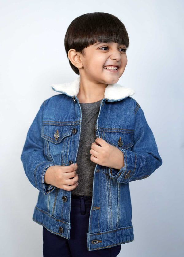 Happy child wearing a stylish mid blue denim jacket with a cozy collar, showcasing playful fashion for kids.