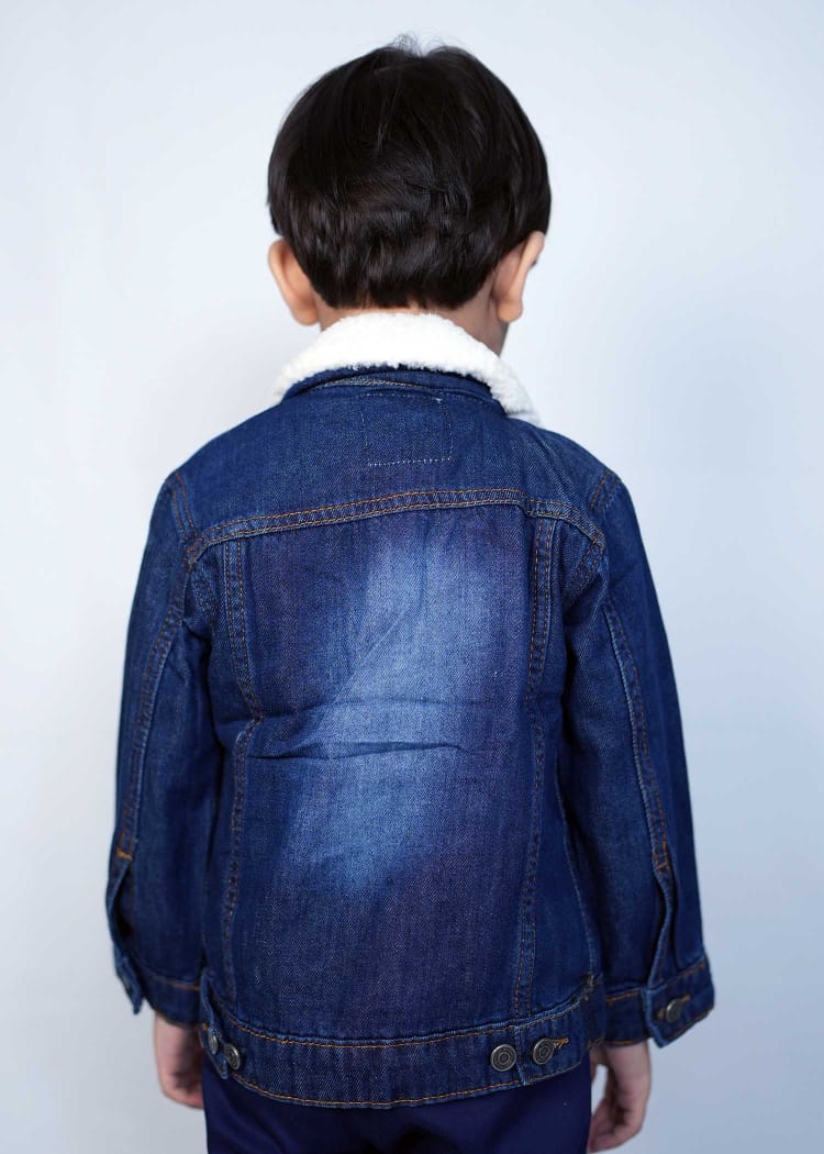 Back view of a kid wearing a dark blue denim jacket with a fluffy collar, showcasing stylish comfort for children.