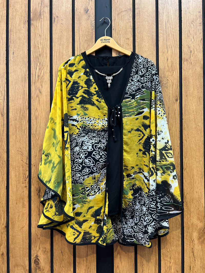 Stylish women's kimono-style jacket with a vibrant yellow, black, and white abstract print displayed on a wooden hanger.