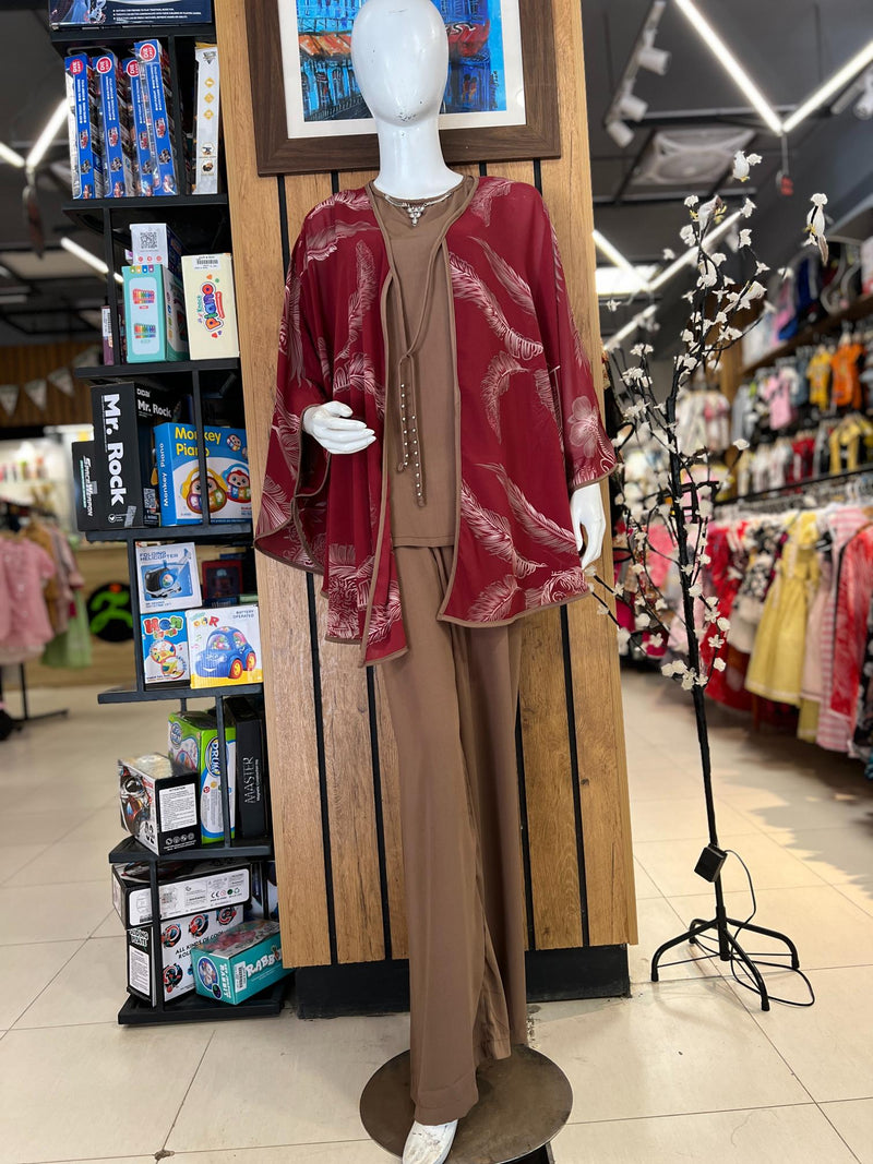 Mannequin modeling a stylish women's three-piece western wear suit with a red jacket, brown waistcoat, and matching slim pants in a retail store.